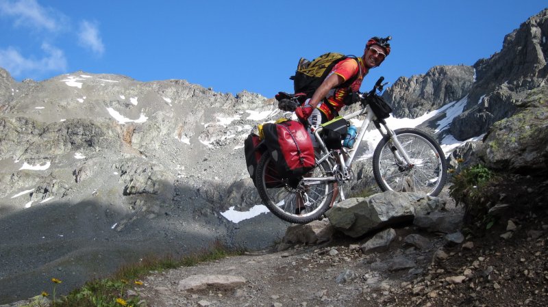 Cris pushes his bike up to Sertigpass (Switzerland)