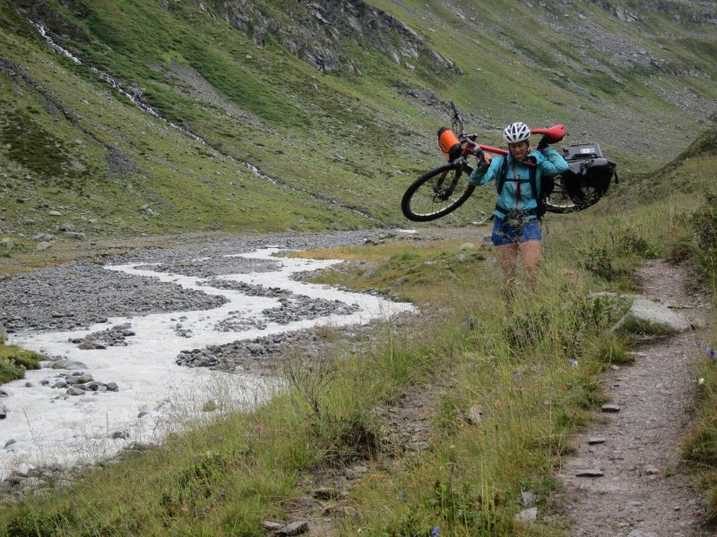 Emily carrying her bike down the rive (Switzerland)