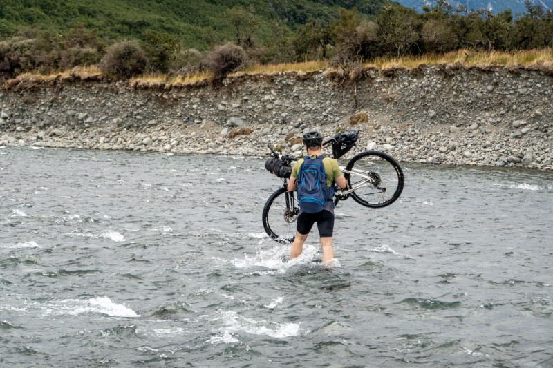 Simon carrying his bike (Bikepacking Poulter Jan 2024)