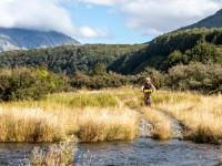 Katie coming up to a stream (Bikepacking Poulter Jan 2024)