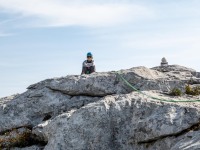 Ari sitting at the top of the climb (Climbing Croatia Oct 2022)