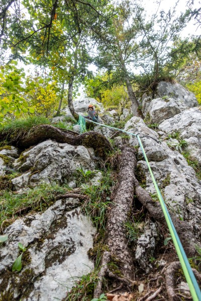Ari belaying from the top of the first pitch (Plombergstein Sept 2025)