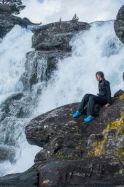 Leonie sitting by the waterfall (Cycle Touring Norway 2016)