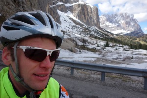 Cris riding with snowy background (Cycling  Dolomites)