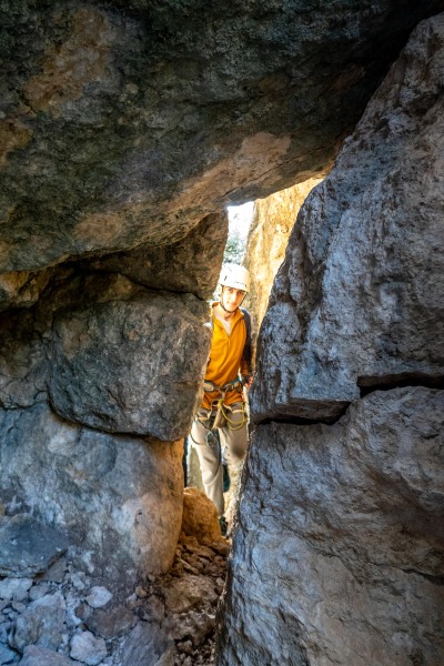 Pol through the rock arch (Ferrata Adventures Ager Oct 2025)