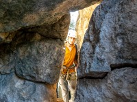 Pol through the rock arch (Ferrata Adventures Ager Oct 2025)