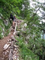 Cris climbs up through the cliffs (Slovenia)