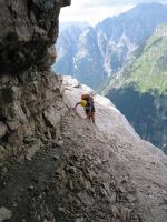 Em climbing near cliff (Triglav Nat. Park, Slovenia)
