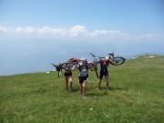 Frauke, Emily, and Cris carrying there bikes to the top of Monte Stivo (Lago di Garda, Italy)