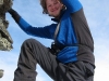 Hallvard climbing the summit cairn (Rørnestinden, Norway)