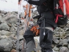 Tim carrying skis through stream (Tomesrenna, Norway)