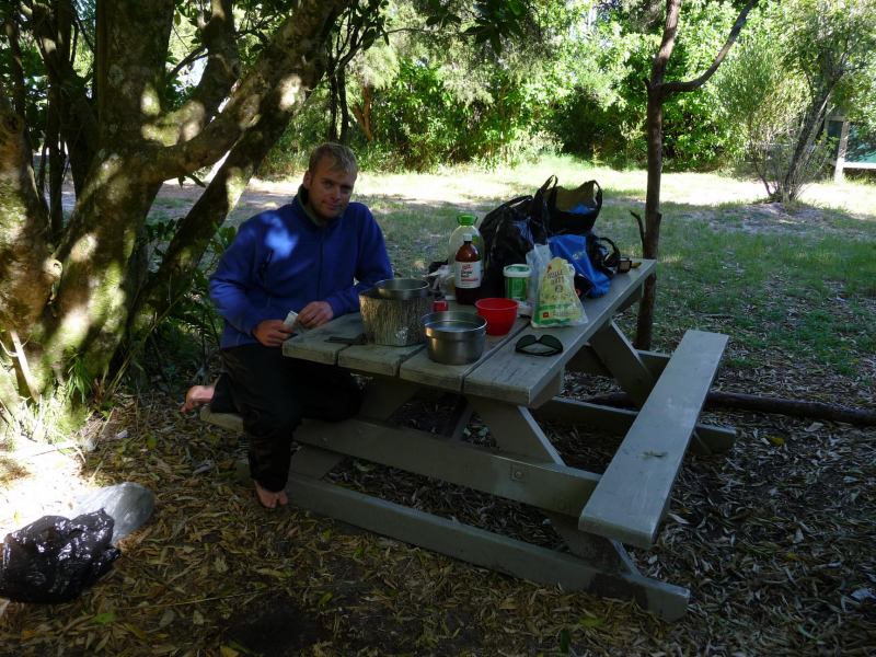 Cris at picnic table at Sandfly Bay (Abel Tasman)