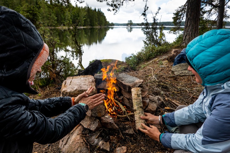 Warming up by the fire (Seakayaking Sweden, August 2024)