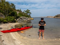 Phil checks the map beside his kayak (Seakayaking Sweden, August 2024)