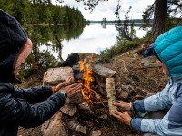 Warming up by the fire (Seakayaking Sweden, August 2024)