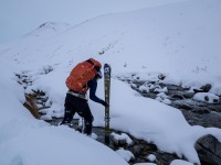Craig crosses the river (Ski Touring Camp Stream Hut Aug 2021)
