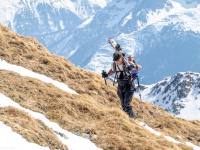 Markus carrying his skis through the grass (Ski touring Weidener Huette March 2022)