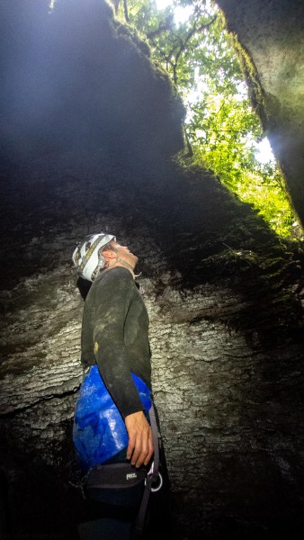 Cris looking up at the exit (Te Tahi cave Jan 2025)