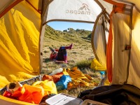 Katie lazing outside the tent (Tramping Mt Alexander Dec 2024)