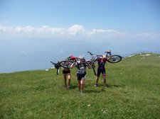 Frauke, Emily, and Cris carrying there bikes to the top of Monte Stivo (Lago di Garda, Italy) resize