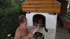Ritchy puts food into the wood oven (Hungary) resize
