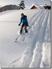 Leonie skiing down in powder (Skitour Stübenwasen)