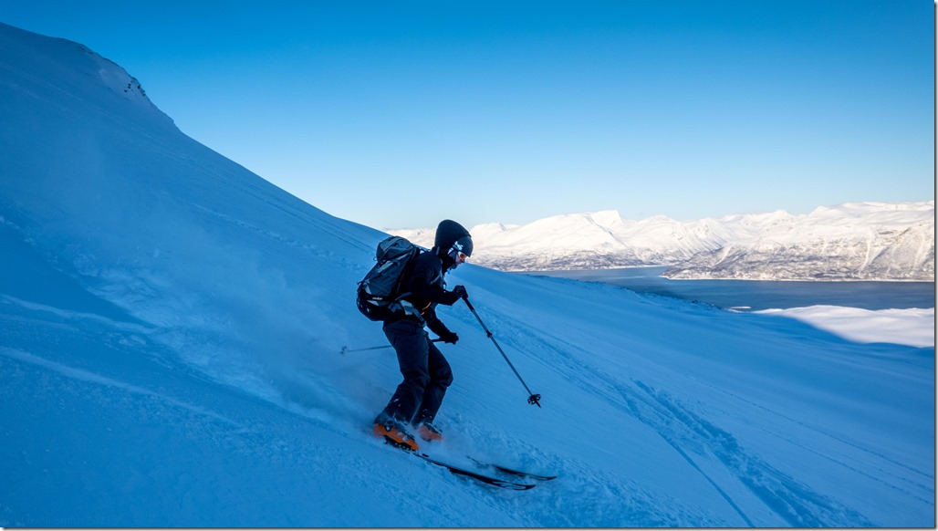Cris skiing down (Day 6, Runfjellet, Ski Touring Lyngen 2023)
